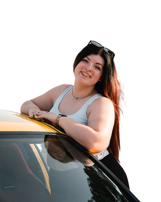 White women in white tank top with brunette hair and glasses on leaning on a yellow car