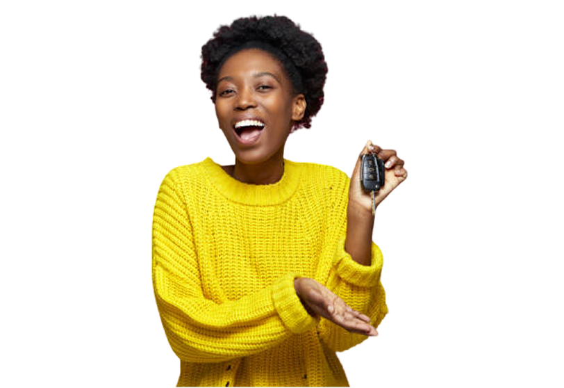 black women in a yellow jumper holding a key, she is skinny and holding a key smiling. she has dark hair.